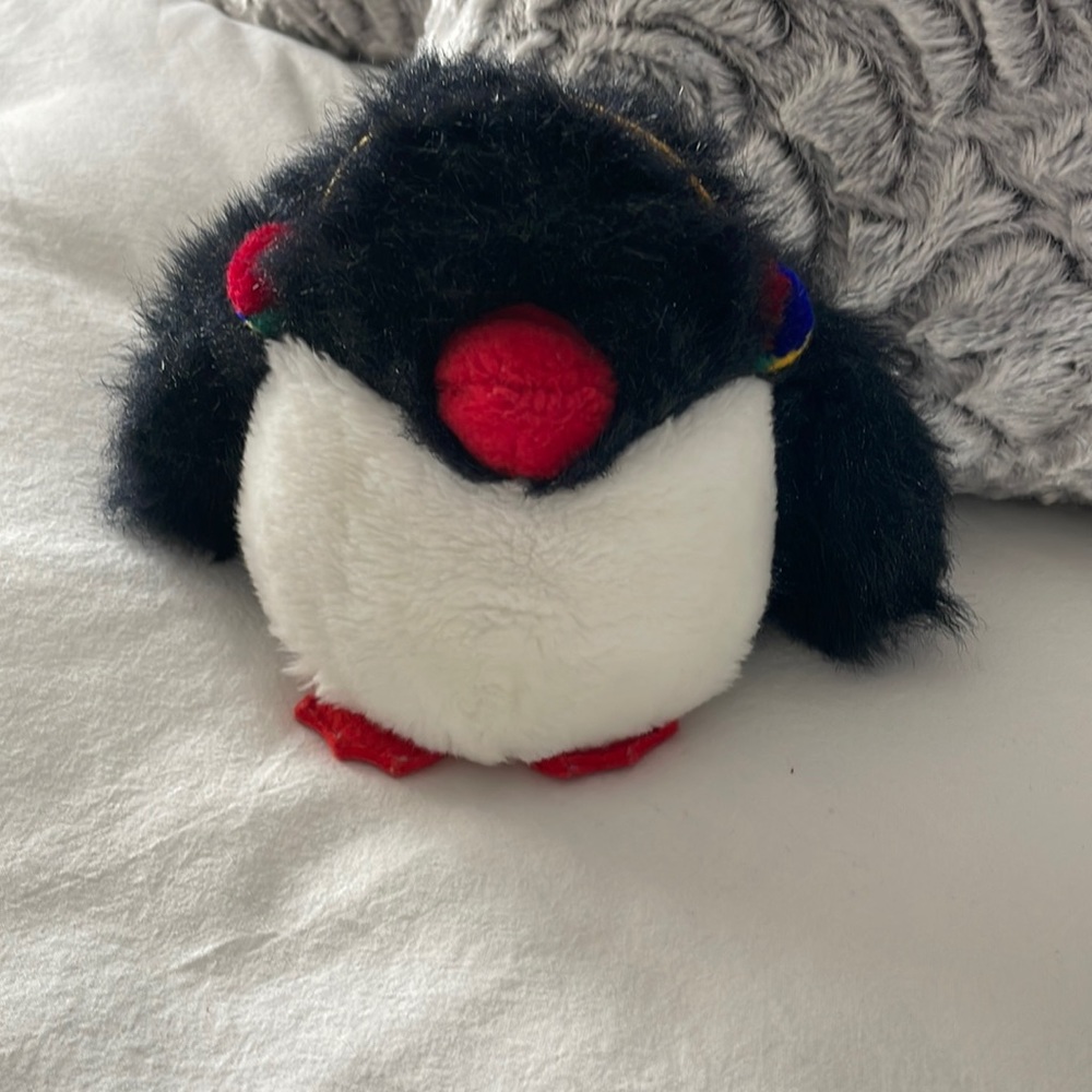 Gund penguin toy wearing earmuffs. Has a squeaker in its left flipper. rare